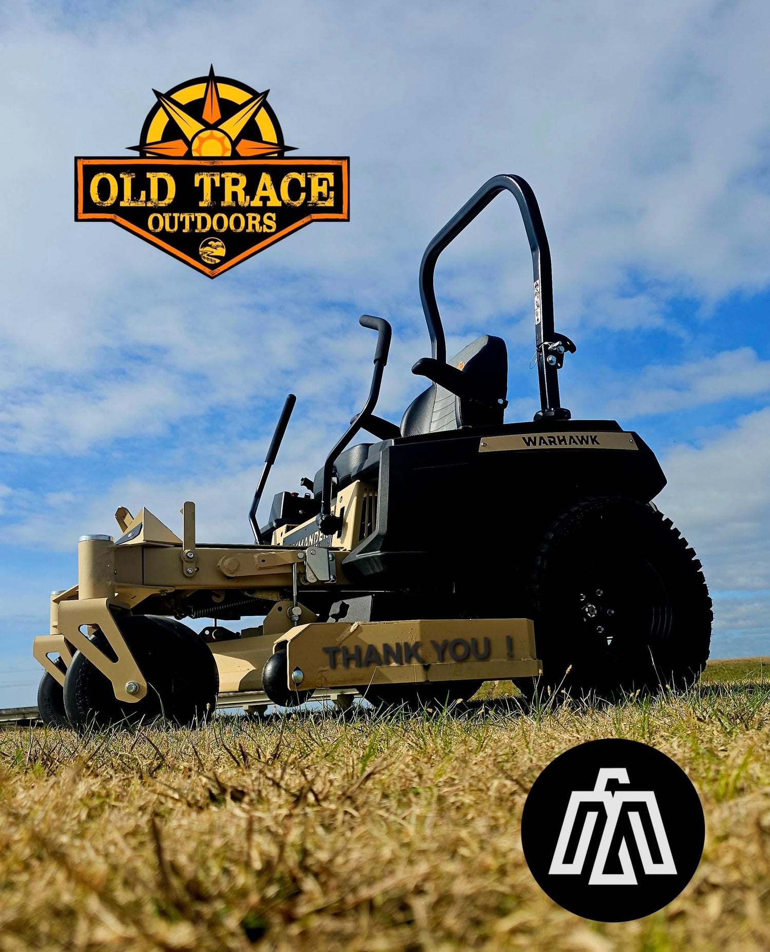 Tan and black Warhawk mower parked in grass